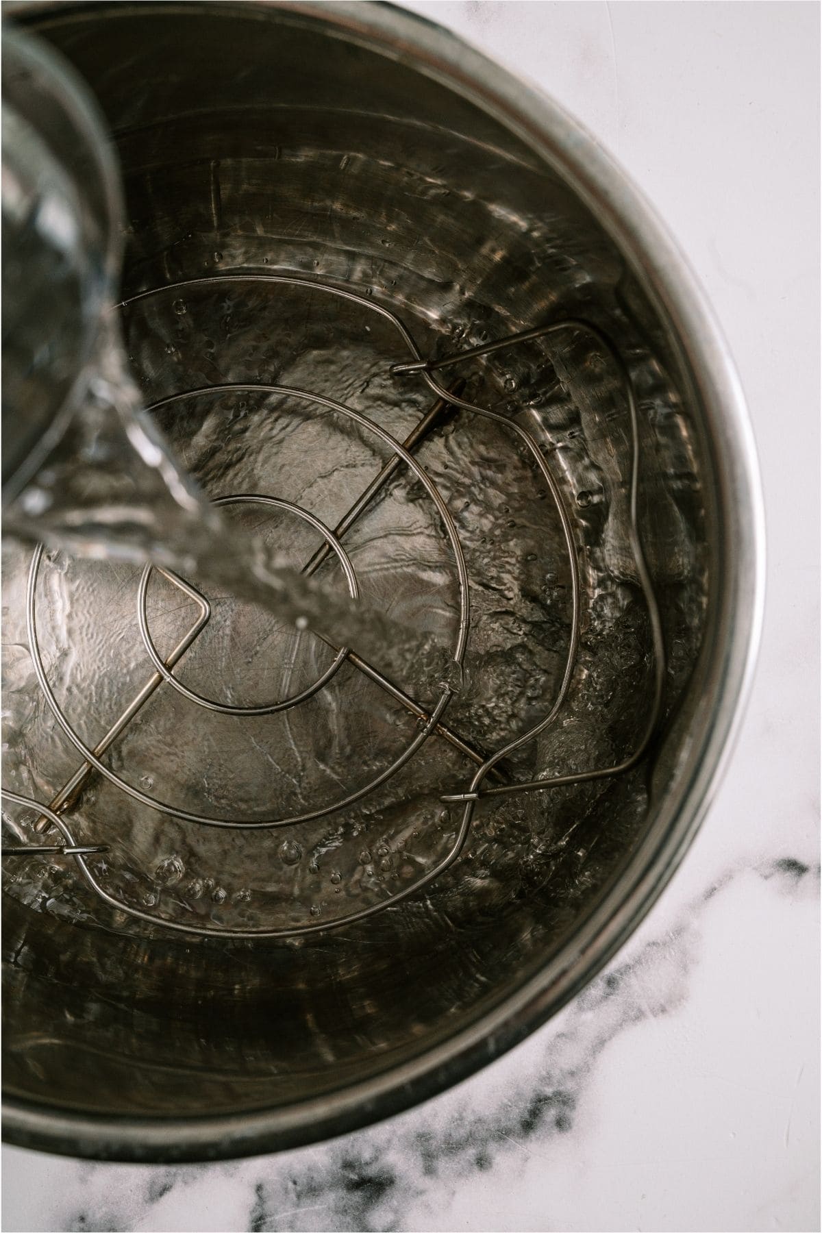 Pouring water in the Instant pot.