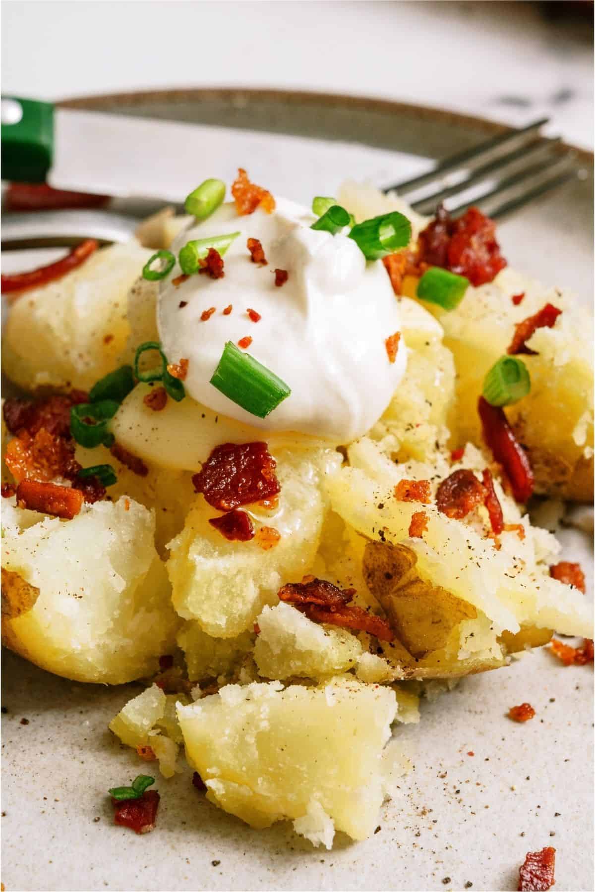 A close up of an Instant Pot Baked Potato with toppings.