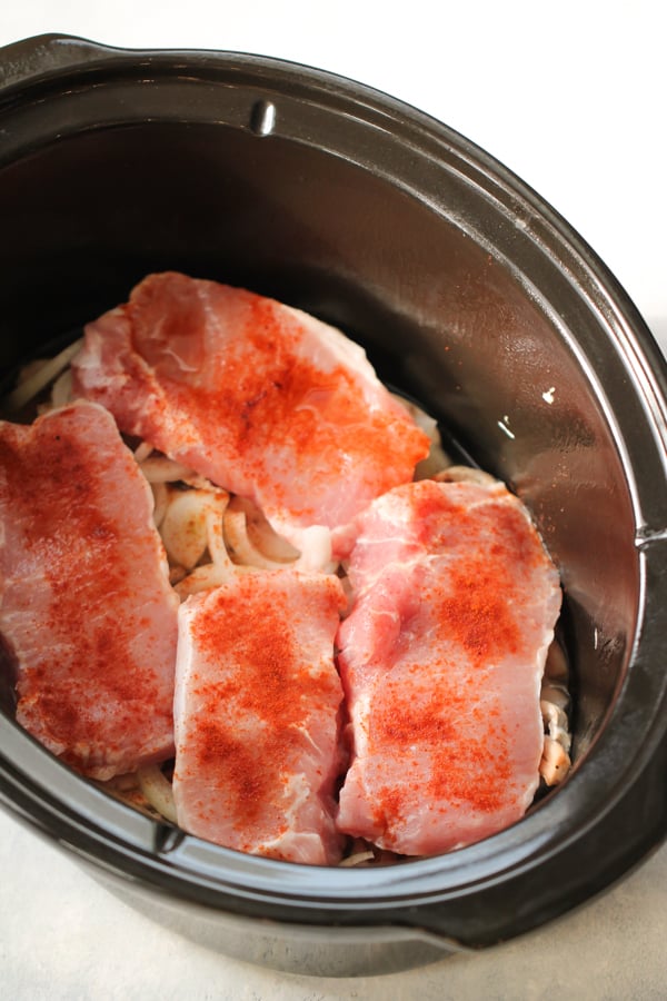 Pork chops seasoned and in slow cooker
