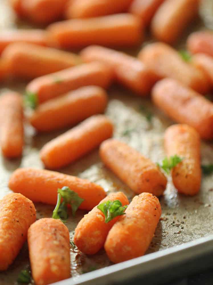 Carrots on baking sheet seasoned and baked