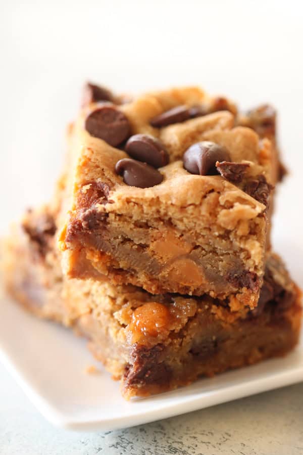 Two Butterscotch Chocolate Chip Blondies squares on a plate