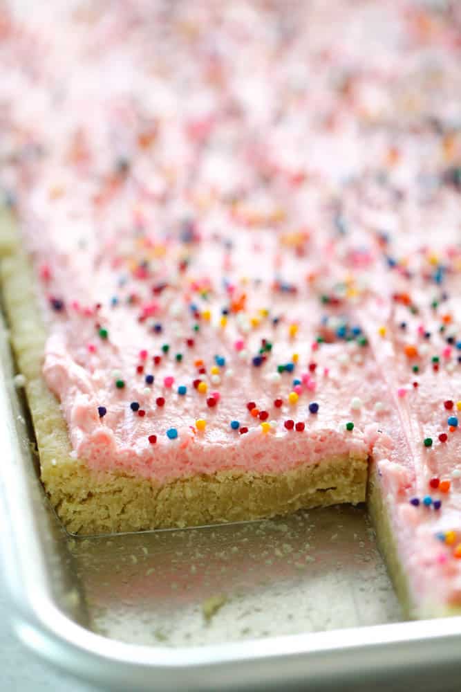 The perfect thick and chewy frosted sugar cookie bars in a sheet pan