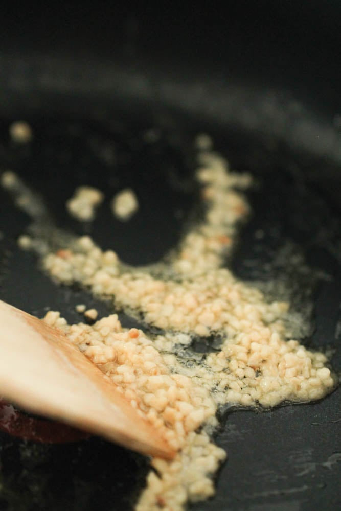 Minced garlic sauteing in a pan