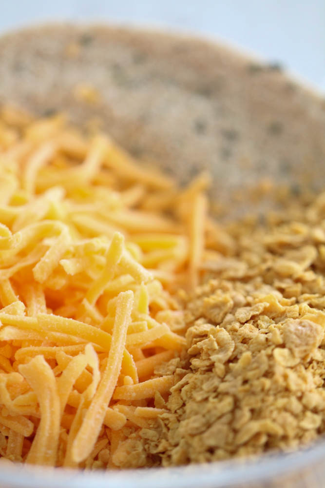 Shredded Cheese, Cornflakes and Bread Crumbs in a shallow bowl