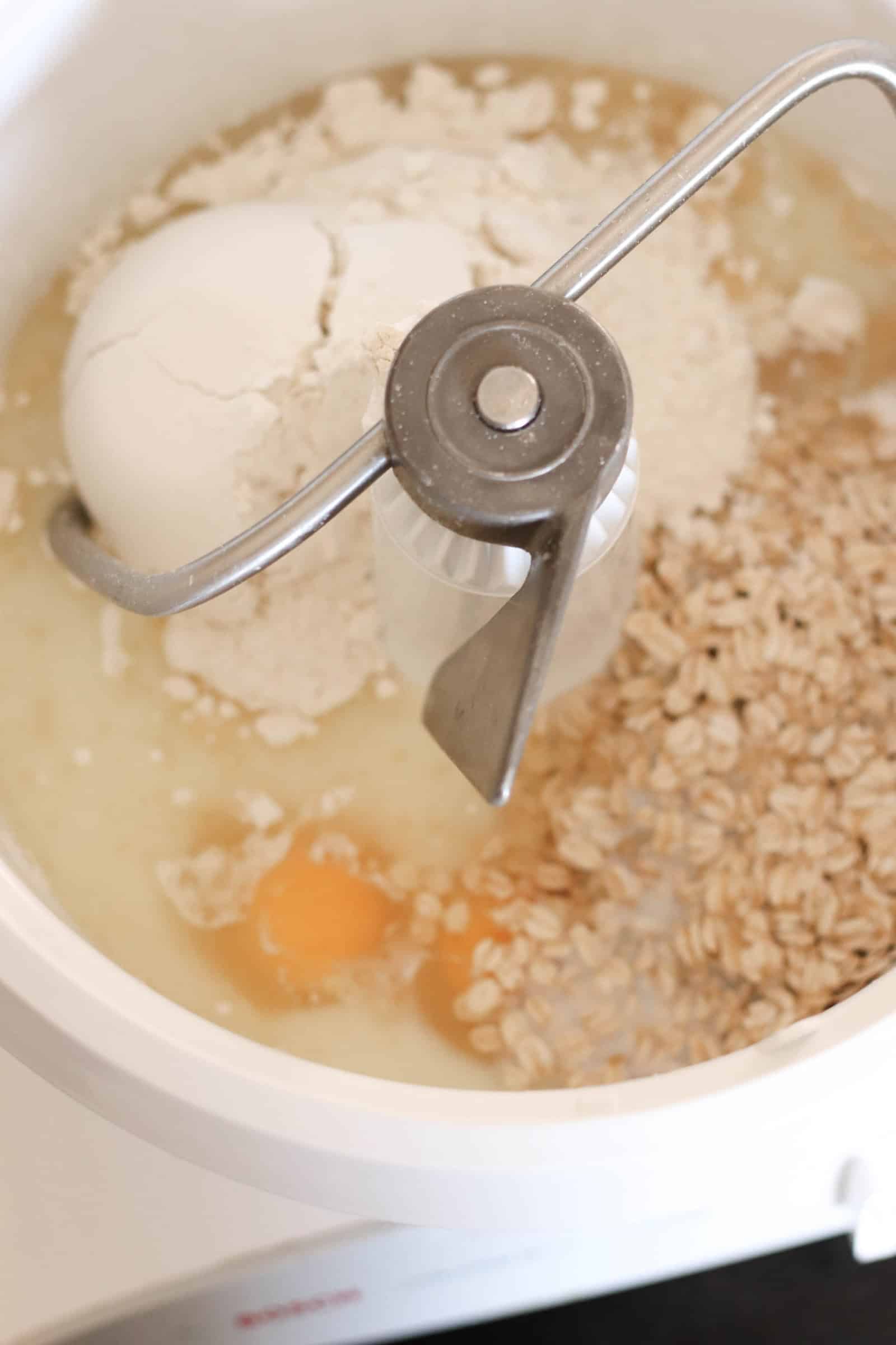 Stand mixer with ingredients inside to make bread dough