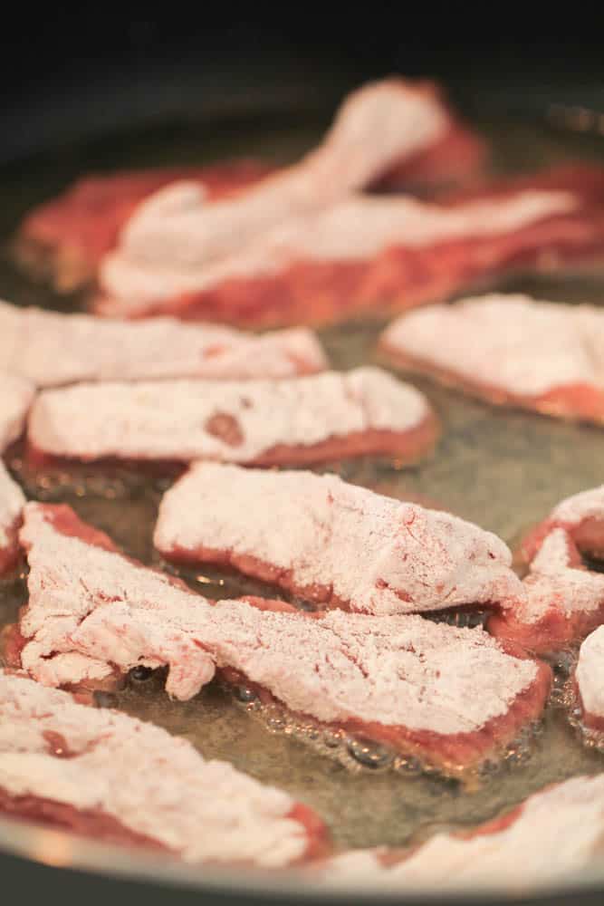 Steak strips iin oil in sauté pan