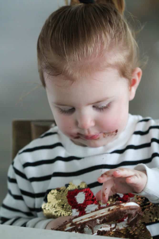 Little girl licking the beater