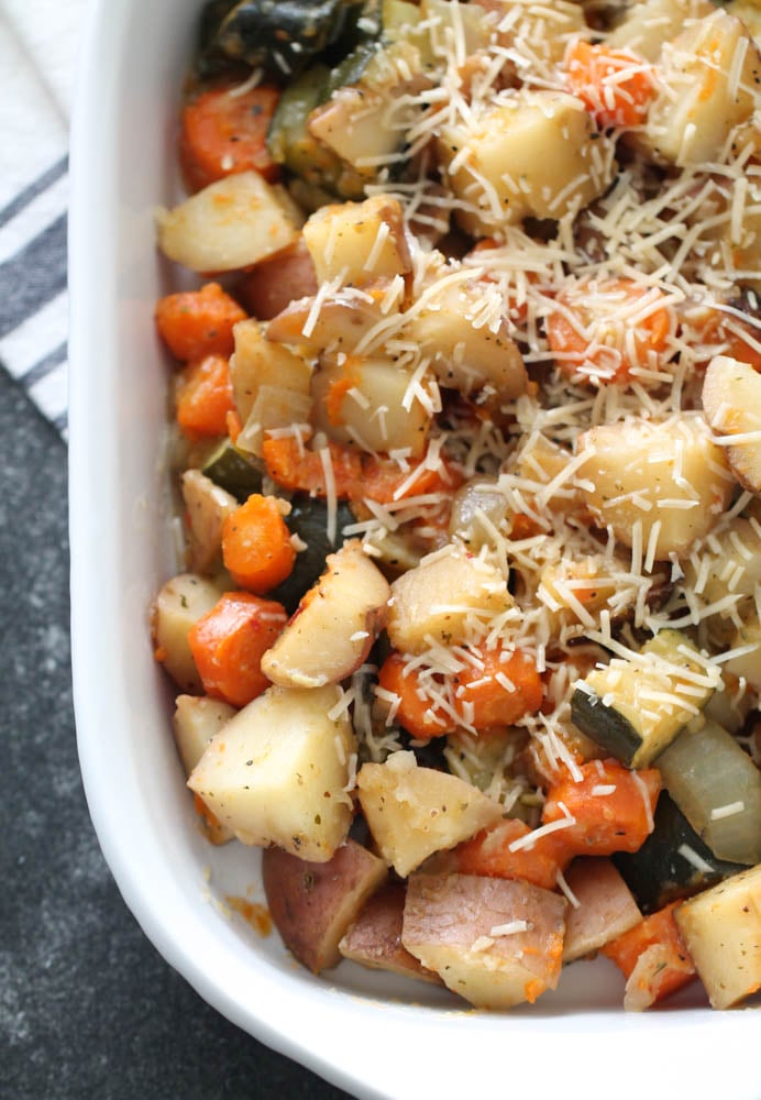 Slow Cooker Roasted Vegetables in a casserole dish topped with cheese
