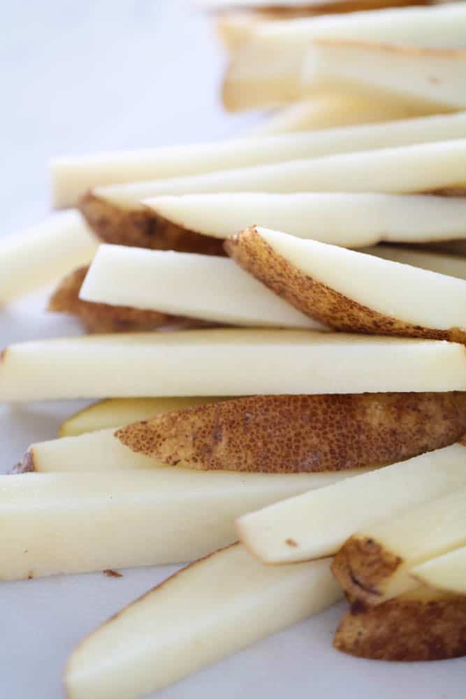 Sliced potatoes on a cutting board