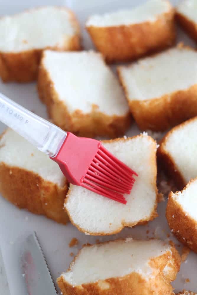 Brushing lemon glaze on Angel Food cake slices