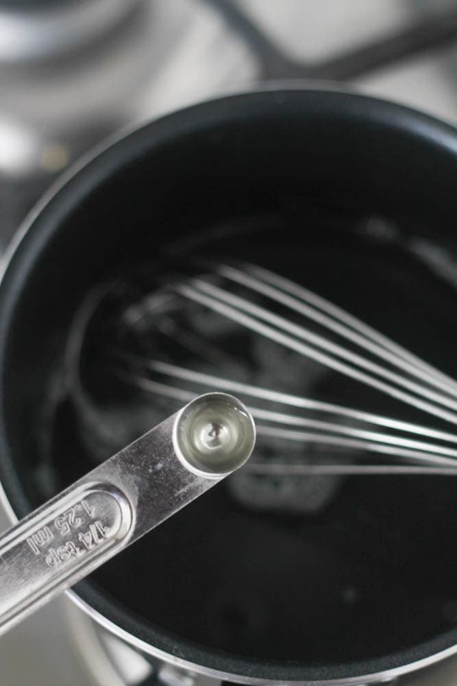 Glaze ingredients in a sauce pan with a measuring spoon