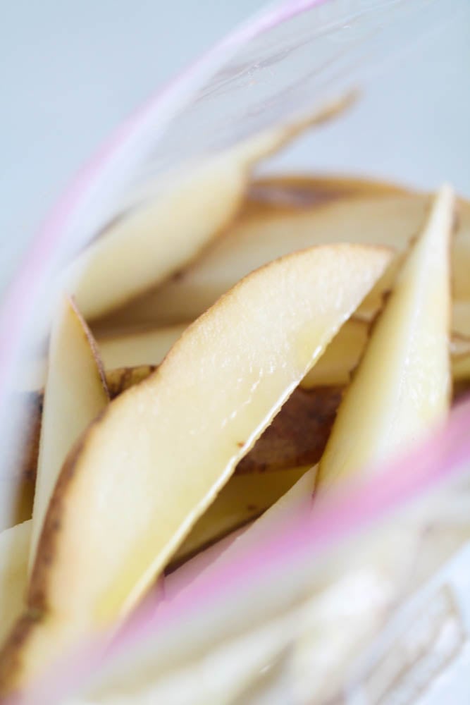 Sliced potatoes in a bag with olive oil
