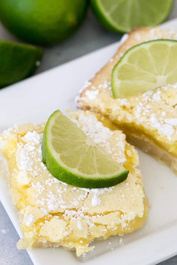 Two slices of Key Lime Bars on a white plate.