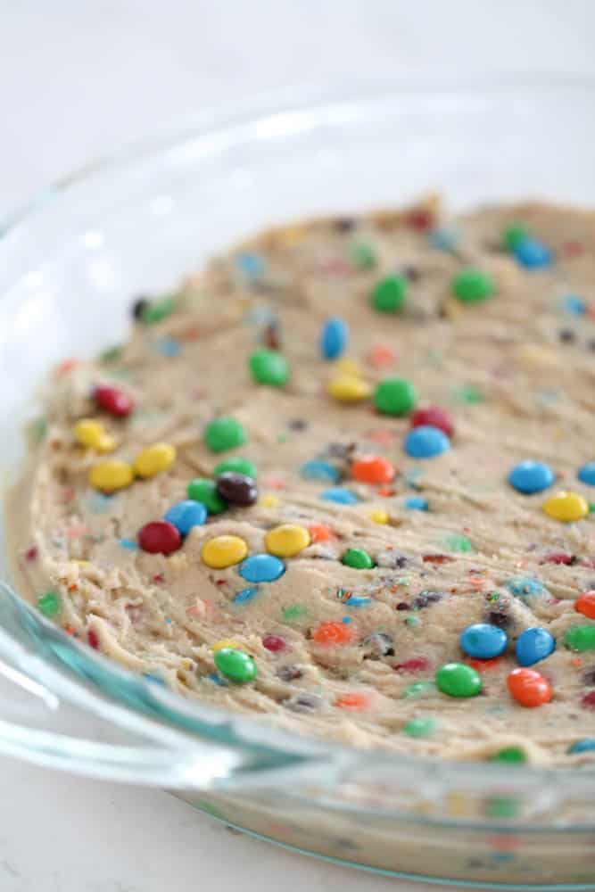Cookie dough for M&M Cookie Pie in glass Pie dish