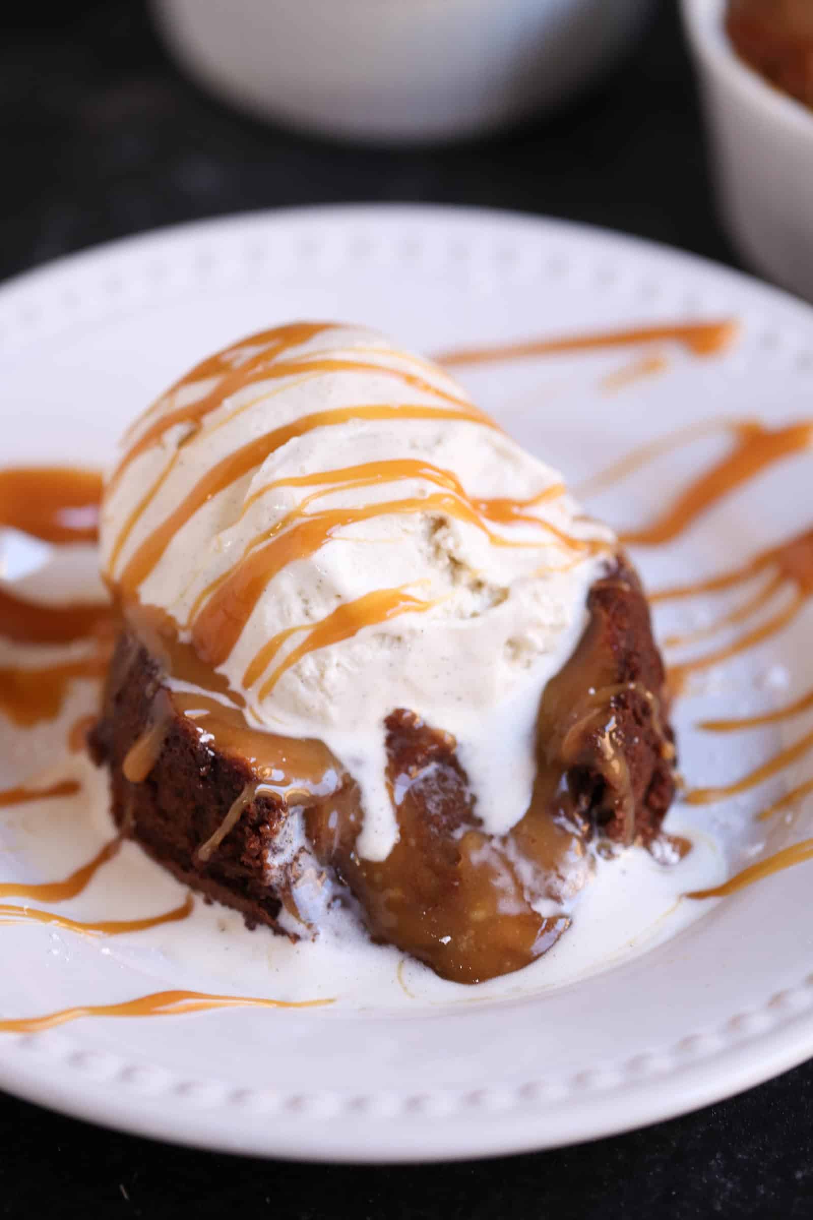 Salted Caramel Lava Cake topped with ice cream on a plate