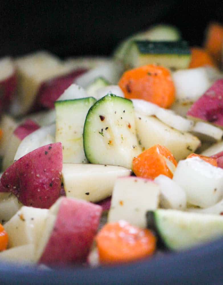 Cut vegetables with seasoning on top in a ziplock bag