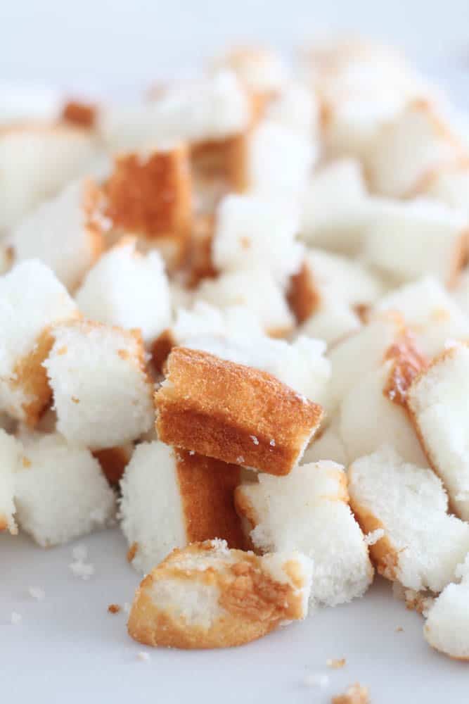 Cubed angel food cake on white counter