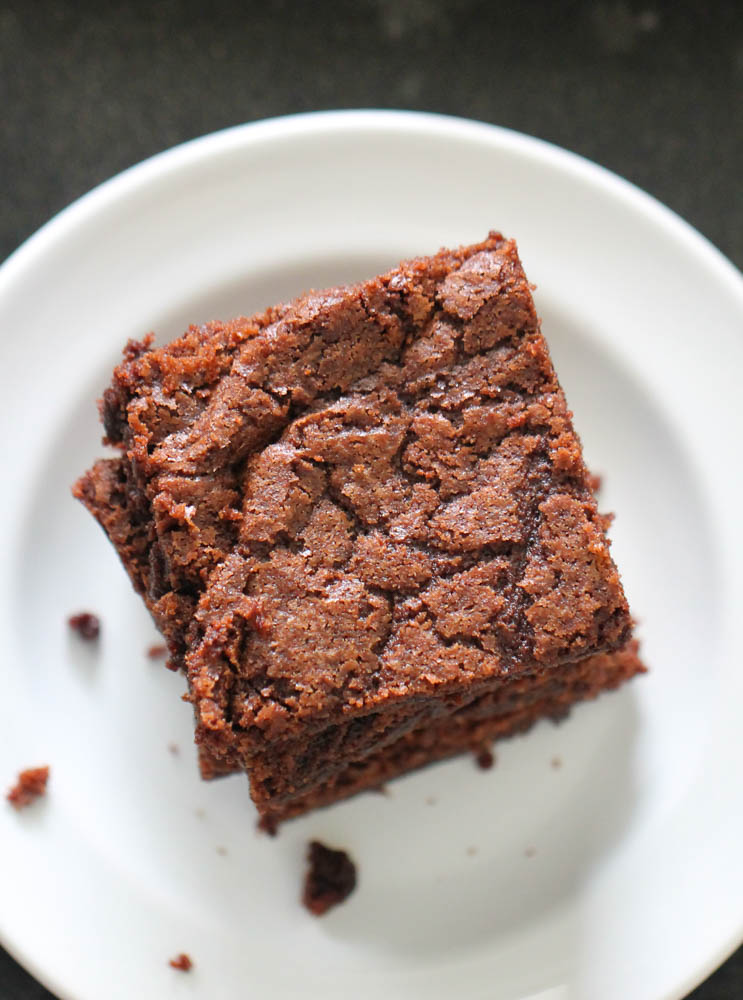 Sheet Pan Fudgy Brownies sliced into squares on a plate