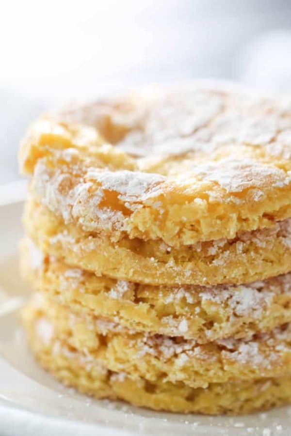 5 Lemon Cake Mix Cool Whip Cookies stacked in a row. Dusted with powder sugar.