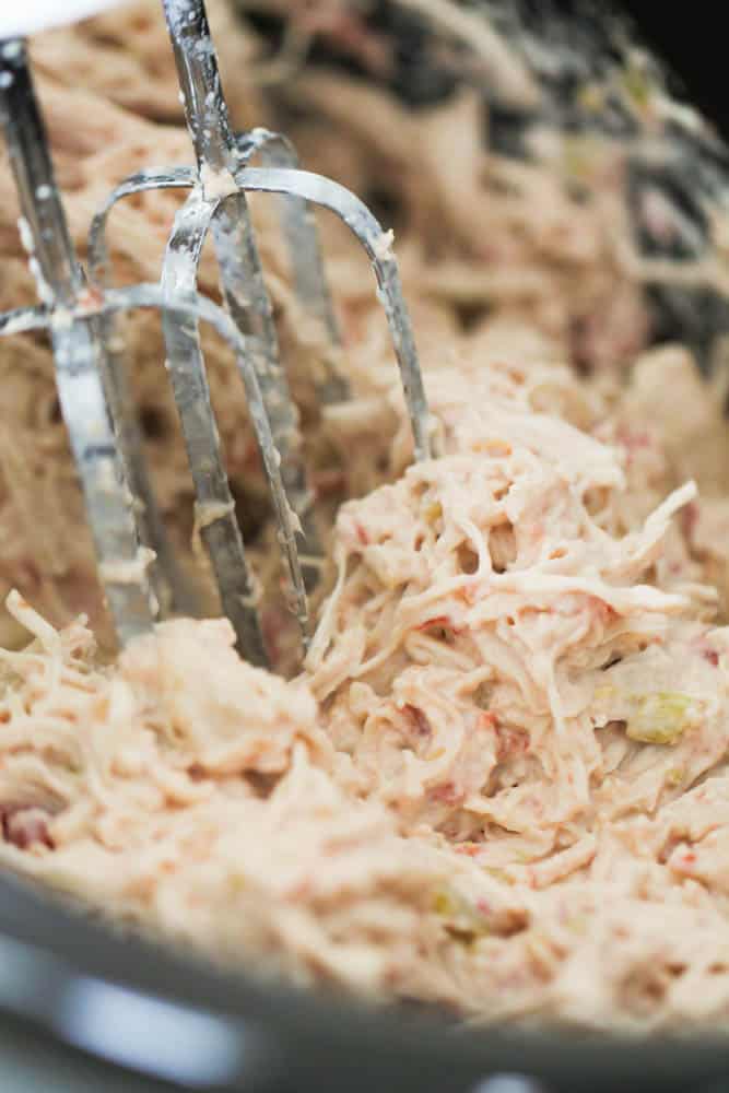 Shredding chicken with a hand mixer in the slow cooker