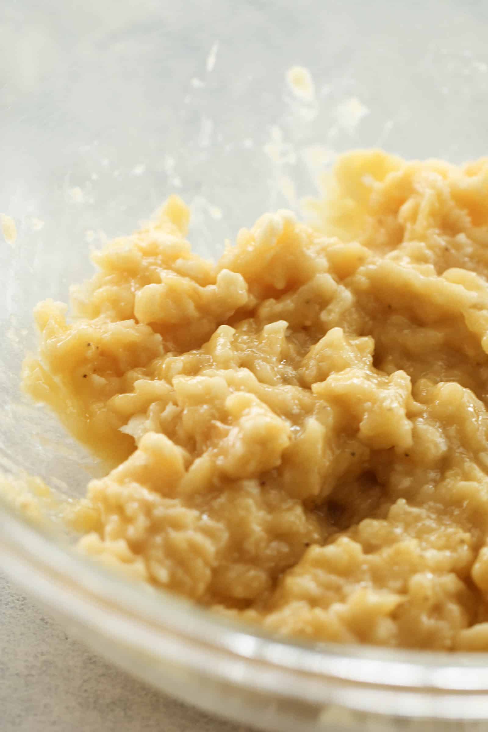 Mashed bananas in a mixing bowl