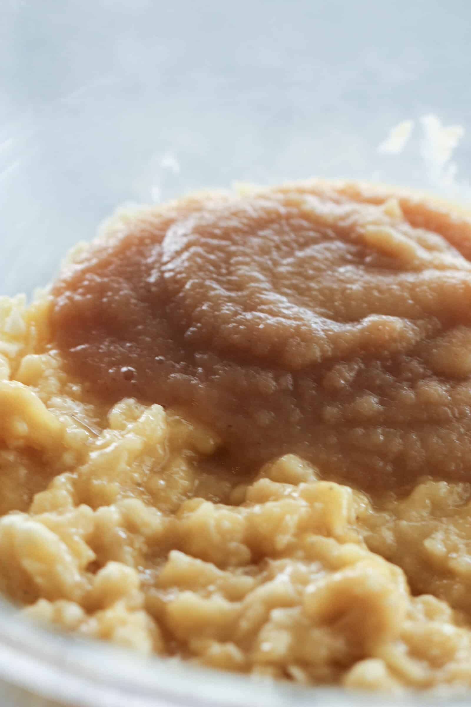 Applesauce and mashed bananas in a mixing bowl