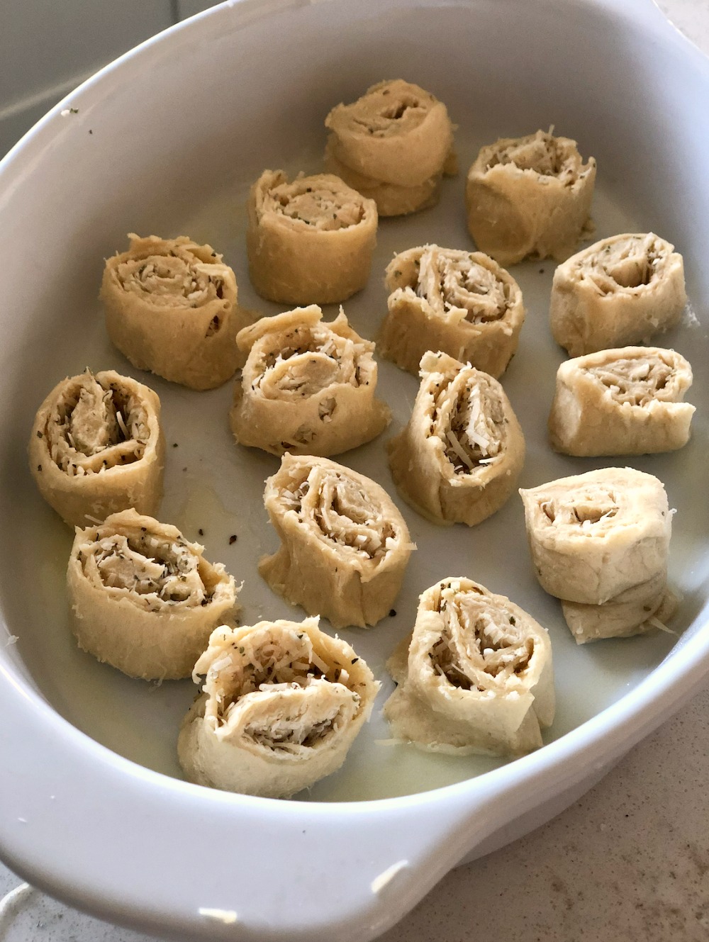 Crescent dough rolls placed in a baking dish
