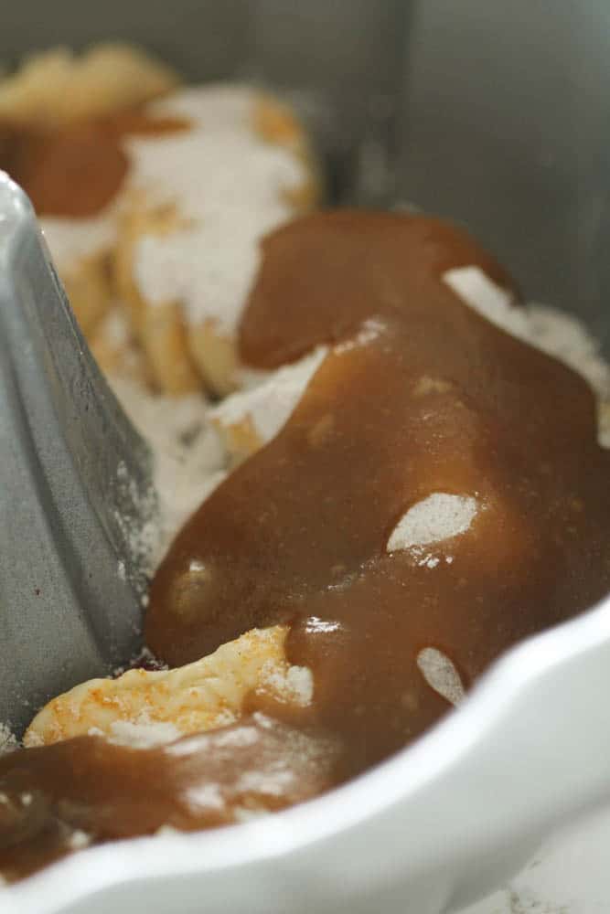 brown sugar and melted butter mixture poured over ingredients in the bundt pan