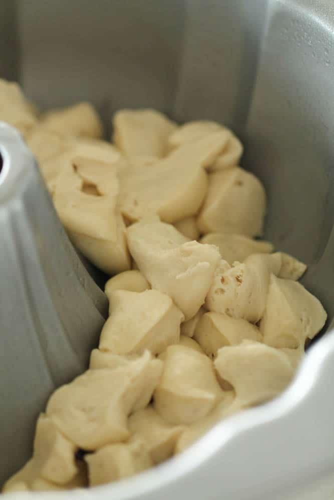 Thawed, chopped roll dough in the bottom of a bundt pan