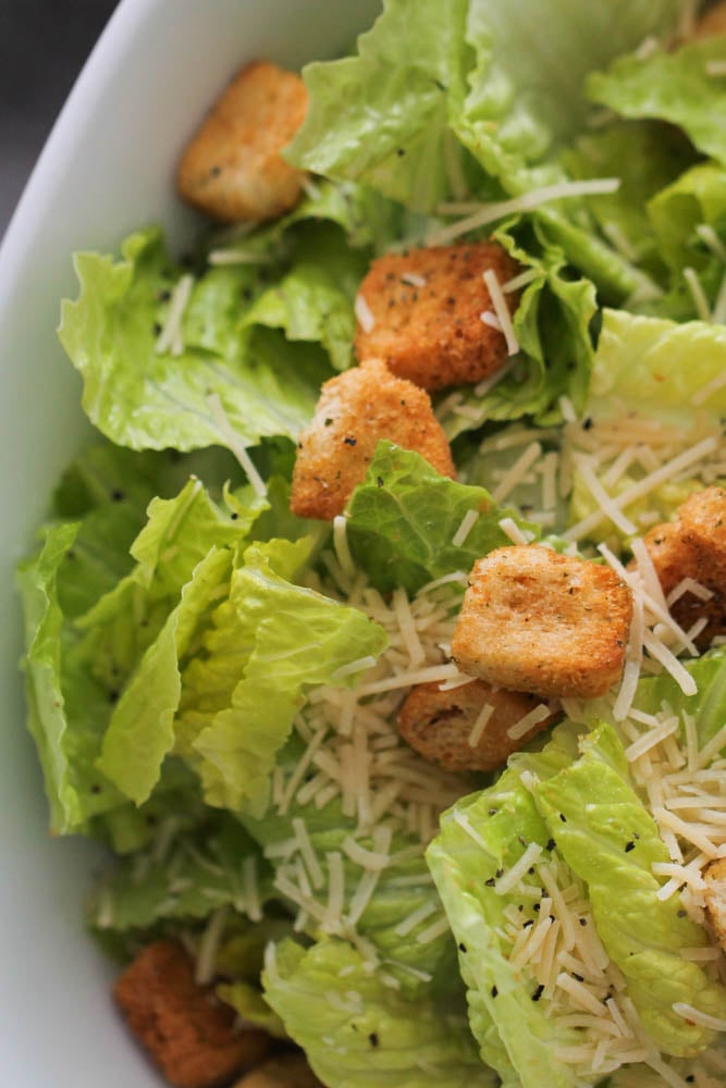 Homemade Caesar Salad and Dressing topped with cheese and croutons