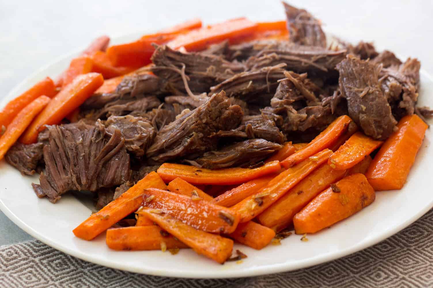 Instant Pot Italian Beef Roast on plate shredded with carrots