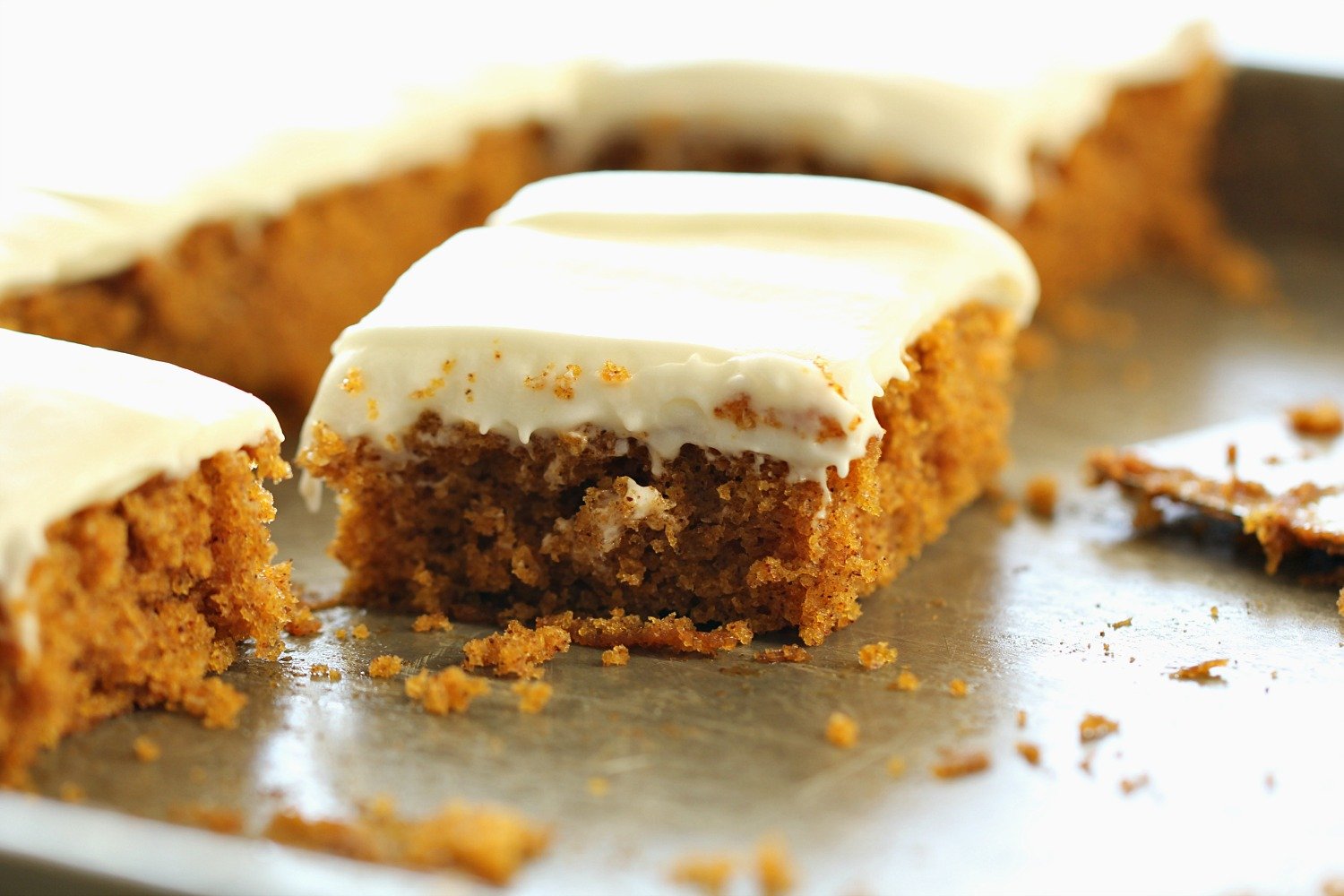 Slice of Sheet Pan Carrot Cake with cream cheese frosting