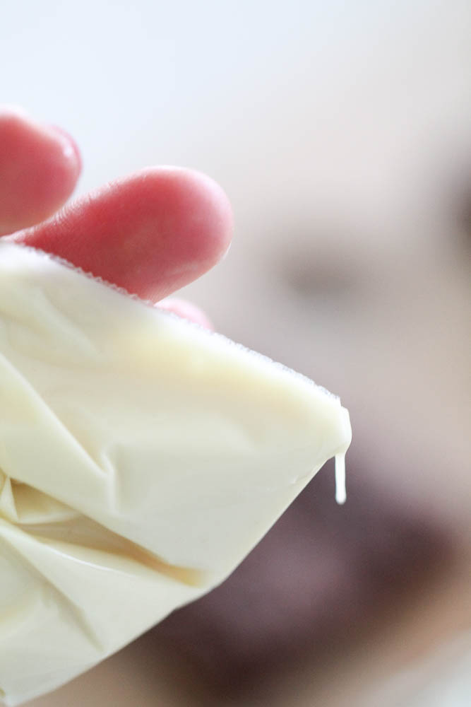 Melted white chocolate in a baggie with the corner cut