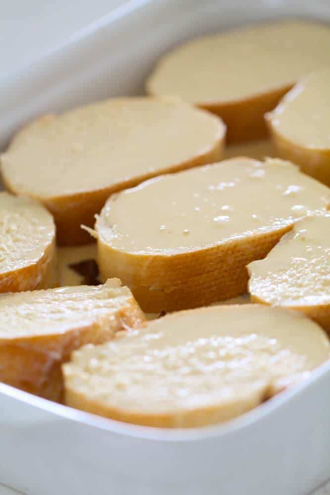 Egg Mixture Covered French Toast Bread laid in a 9x13 baking dish