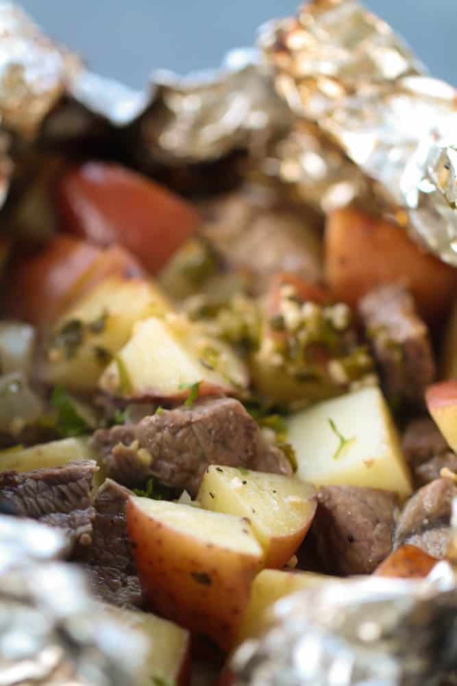 Steak and Potato Foil Pack Dinners on a plate opened up