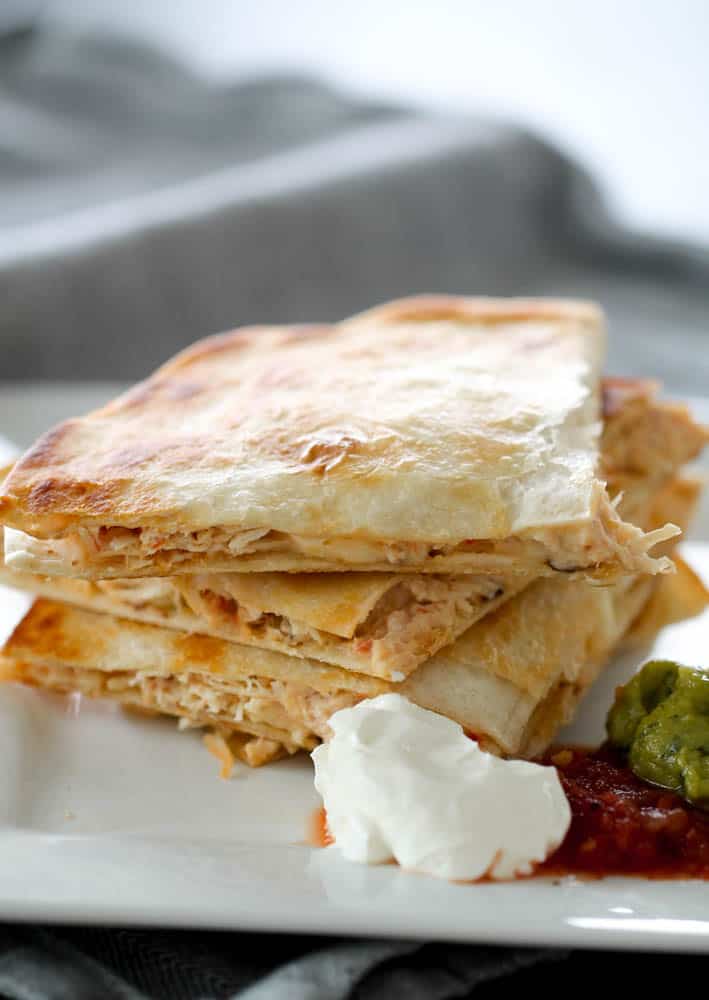 Slow Cooker Cheesy Chicken Quesadillas cut into triangles stacked on a plate