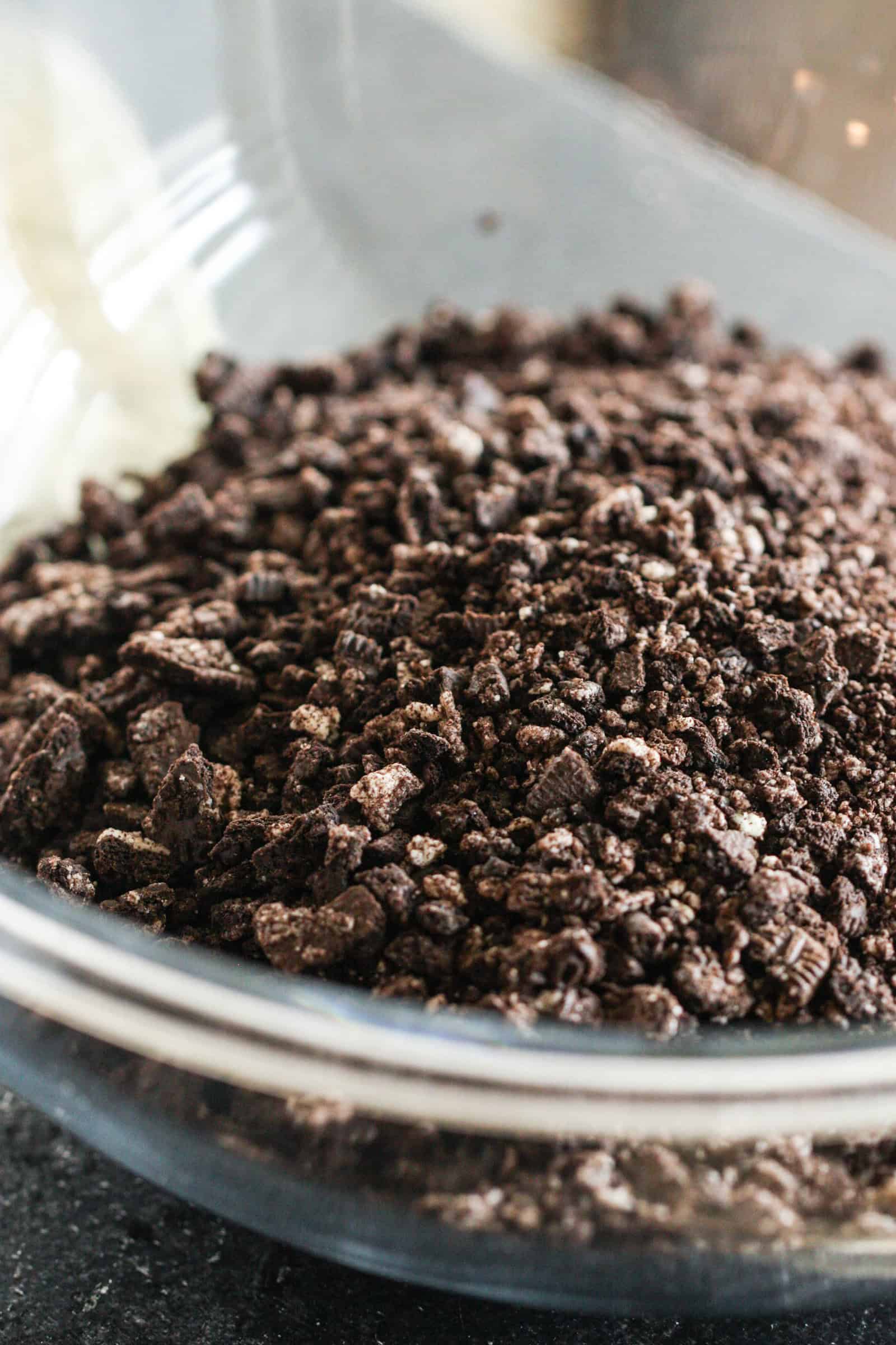 Crushed oreos in a glass pie dish