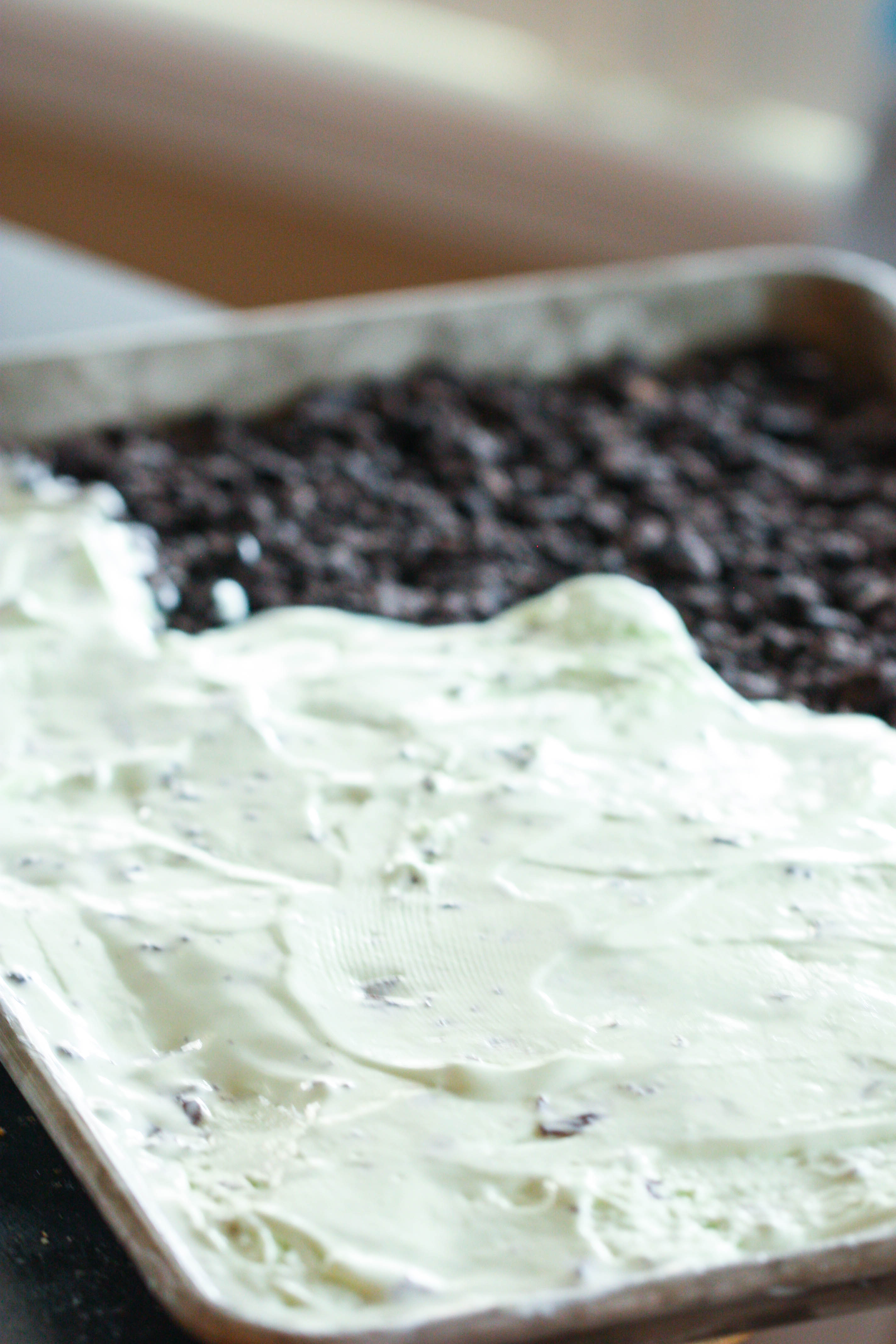 Mint chocolate layer spread on top of crushed oreo layer