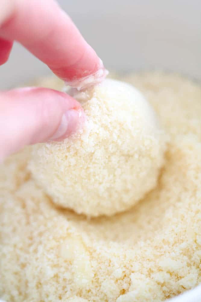 Rolling frozen roll in parmesan cheese mixture