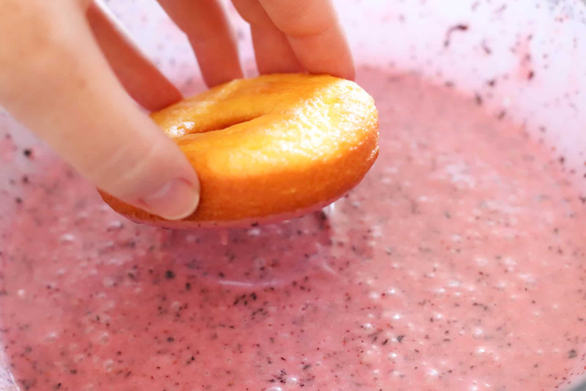 Dipping the lemon donut in frosting