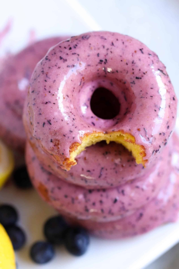 lemon donuts with blueberry frosting with a bite taken out of it