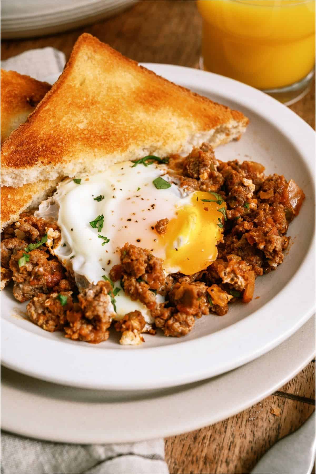 One Pan Egg and Turkey Skillet on a plate with a side of toast.