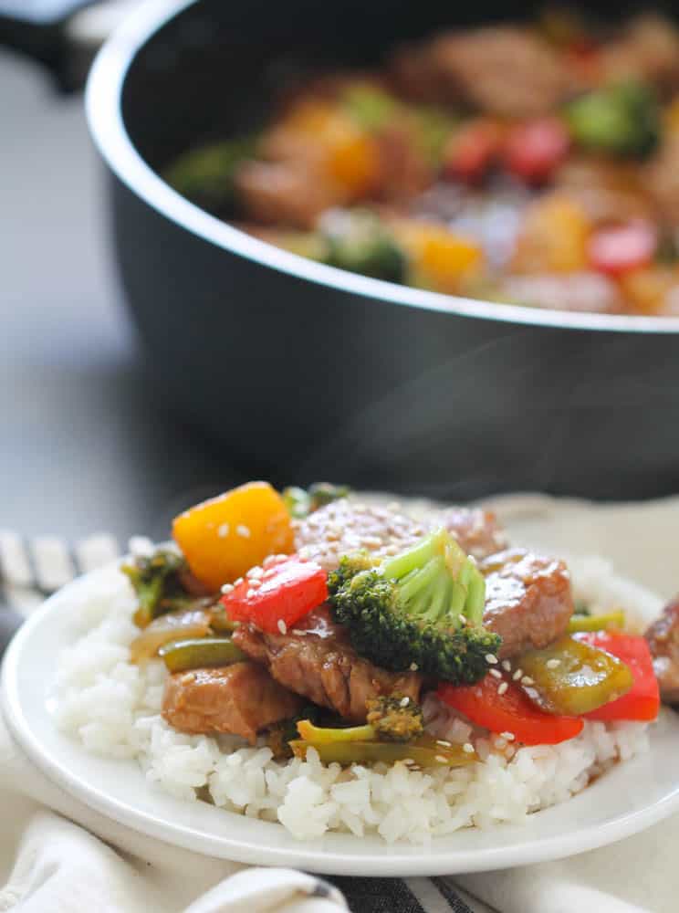 Teriyaki Pork Stir Fry served over rice on a plate