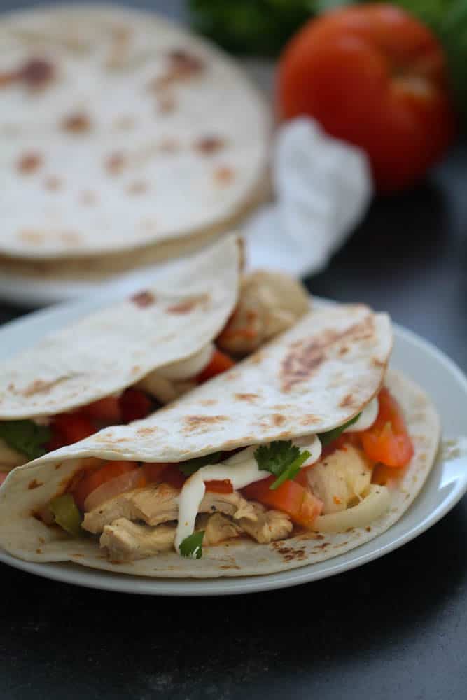 Marinated Chicken Fajitas in flour tortillas on a plate