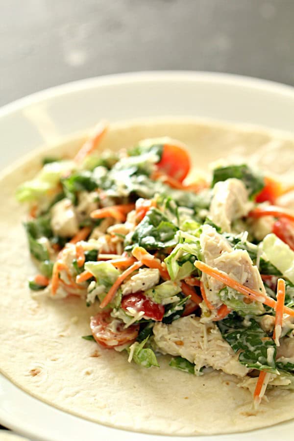 10 Minute Healthy Chicken Caesar Salad Wrap filling on a tortilla