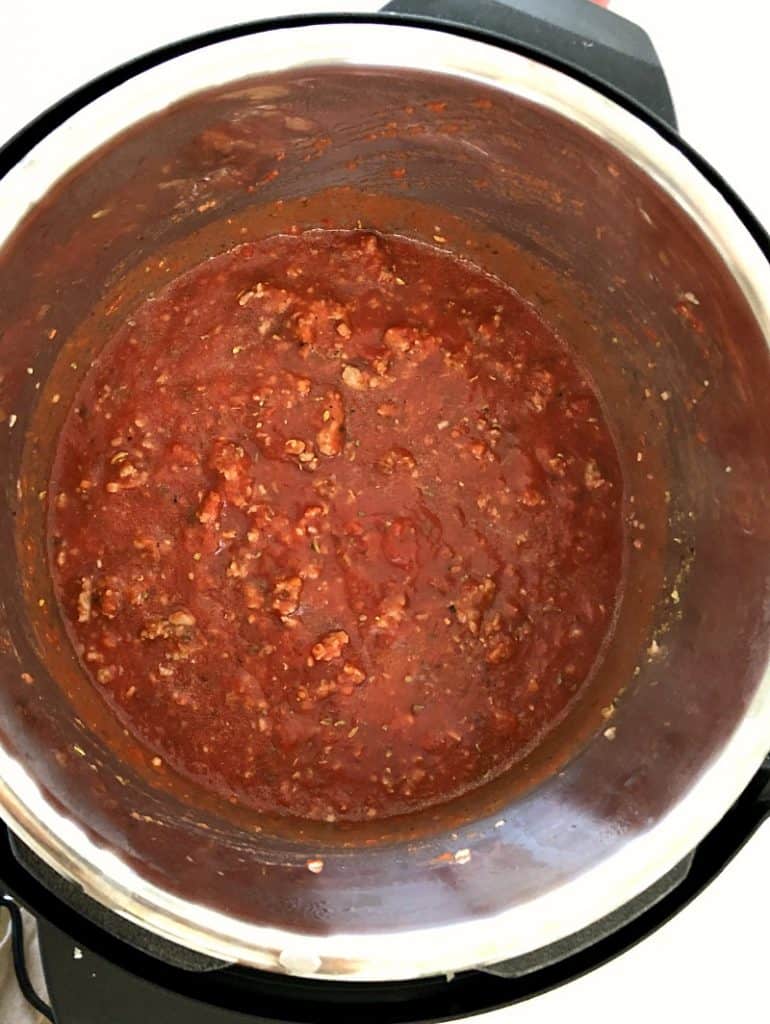 Sauce added to ground italian sausage in an instant pot.