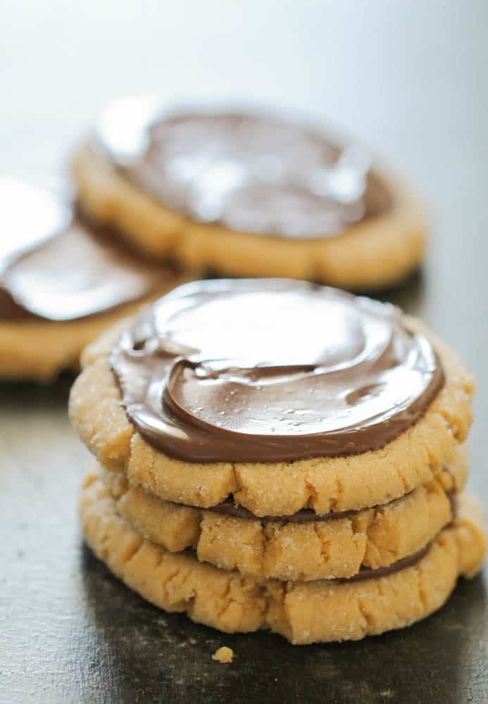 stack of 3 peanut butter cookies frosted with nutella hazelnut spread on top