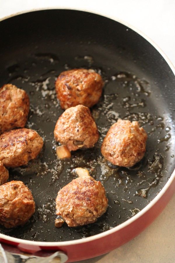 meatballs cooking in large skillet
