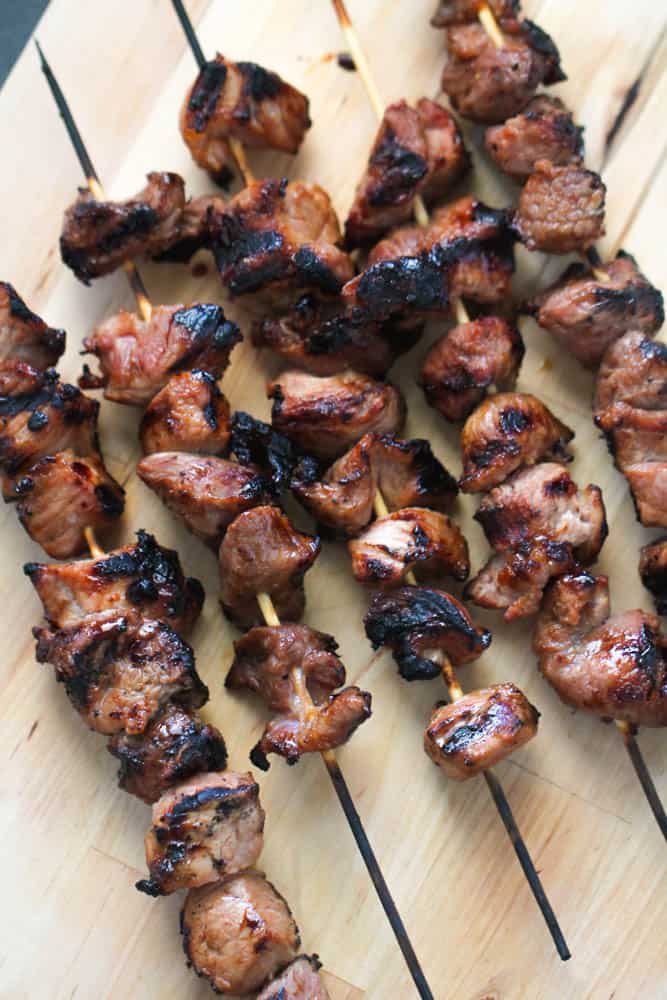 Grilled BBQ Pork Skewers on a cutting board