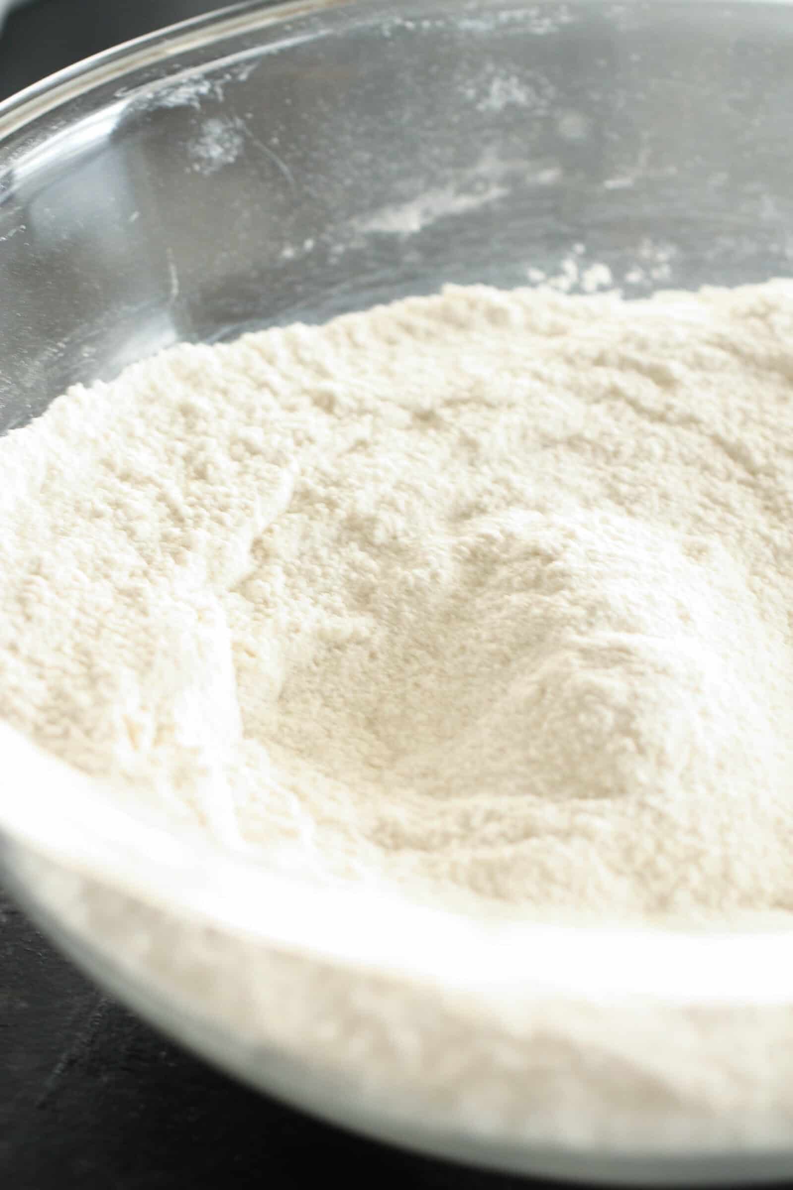 Dry ingredients for Turtle Texas Sheet Cake in a glass bowl